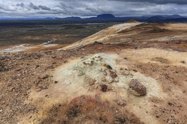 Geothermal field and sulphur springs in front of mountain landscape, clouded, Namafjall, Myvatn, North Iceland, Iceland, Europe