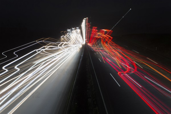 A7 Motorway, Autobahn, beside Kassel at night with light trails from the traffic headlights and taillights, an abstract image, Hesse, Germany, Europe