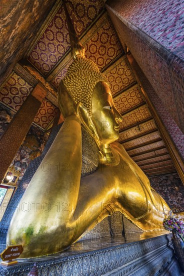 The reclining Buddha in Wat Pho temple, reclining, rest, resting, Buddhism, religion, world religion, sculpture, sculpting, art, statue, culture, believing, faith, peace, Asian, travel, holiday, tourism, representation, palace, tradition, traditional, decoration, decorated, house of prayer, building, attraction, landmark, gilded, gold, holy, pray, meditation, monastery, spirituality, meditate, spiritual, monument, famous, sight, philosophy, architecture, capital, Bangkok, Thailand, Asia