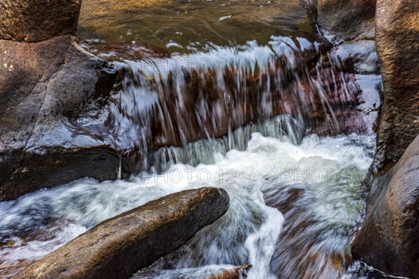 Small river and cascade with water flowing between the rocks, Minas Gerais, Brazil, South America