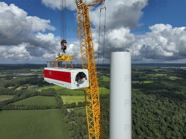 Dorsten, North Rhine-Westphalia, Germany, construction of a wind turbine, the first wind turbine of the Große Heide wind farm. A large mobile crane places the nacelle, the nacelle on the tower, Europe