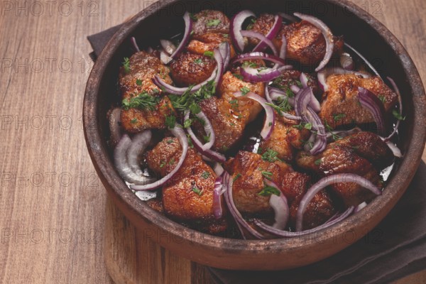 Fried meat, pork kebab, ketsi in a clay pan, with red onions and herbs, homemade, no people