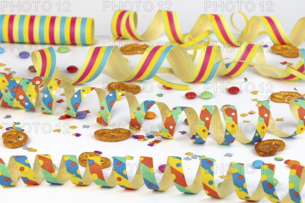 Colourful streamers, confetti and pretzels as party table decorations, carnival