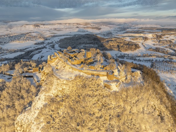 Aerial view of the snow-covered Hegau volcano Hohentwiel with Germany's largest castle ruins on a cold winter morning, at sunrise, district of Constance, Baden-Württemberg, Germany, Europe