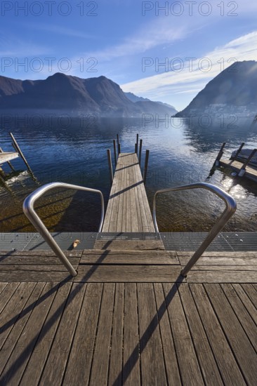 Jetty, wooden planks, stainless steel railing, bird's eye view, lake, jetty, mountain landscape, haze, backlight, blue sky, cirrus clouds, veil clouds, Lake Lugano, Lugano, district of Lugano, canton of Ticino, Switzerland, Europe