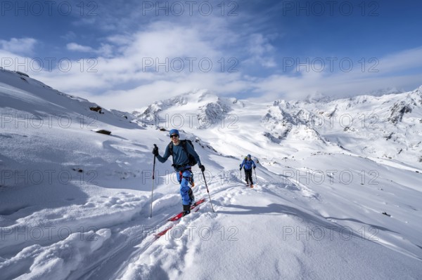Ski tourers in a snow-covered mountain landscape, mountain peak Monte Cevedale and glacier Zufallferner, ascent to the summit Köllkuppe or Cima Marmota, Ortler Alps, Vinschgau, Italy, Europe