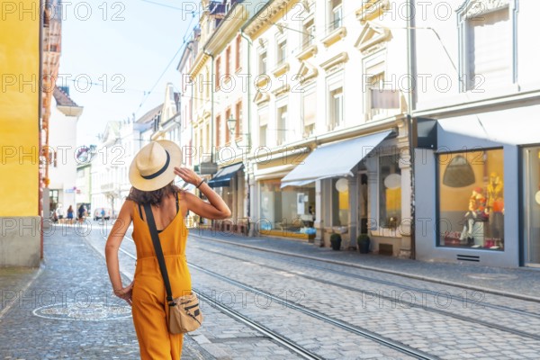 A female tourist walking through the city of Freiburg im Breisgau, Germany, Europe