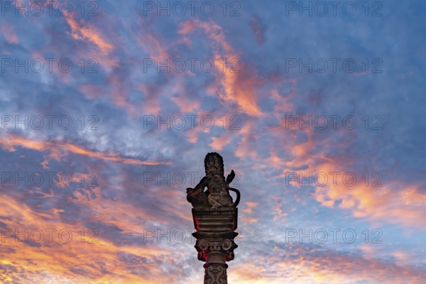 Sunset over the lion of the Löwenbrunnen in Neckarsulm, Baden-Württemberg, Germany, Europe