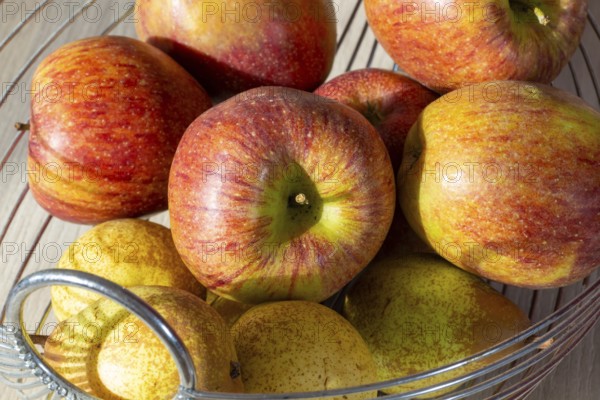 Close-up of apples and pears in the fruit basket
