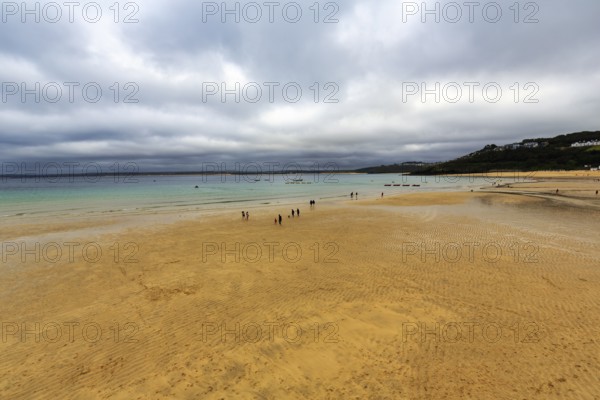 Walkers on the beach at low tide, cloud cover, St. Ives, England, Great Britain