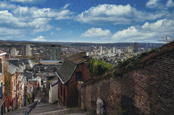 Montagne de Bueren, staircase with 260 metres length and 67 metres height difference, from old town Liège to residential area, houses on the left and right, blue sky with clouds, view of the city from top to bottom and into the distance, Liège, Belgium, Europe