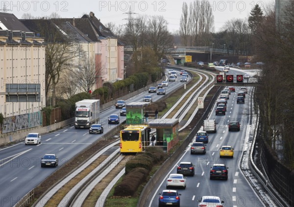 Essen, North Rhine-Westphalia, Germany - Cars and a public bus drive through Essen city centre on the A40 motorway