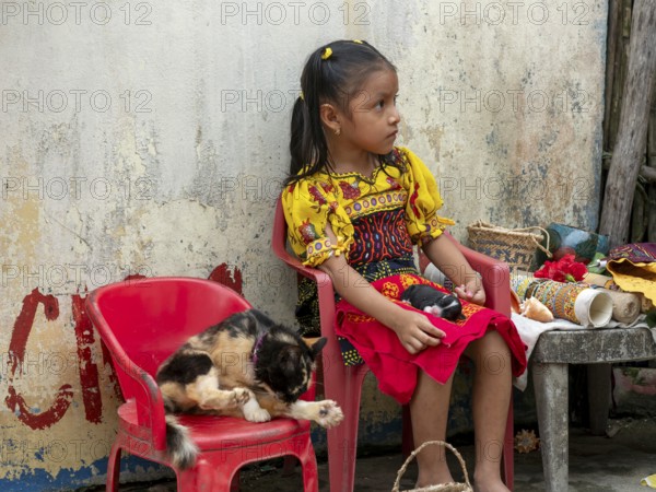 Bocas del Toro Indigenous Guna child with cat on San Blas Islands Panama