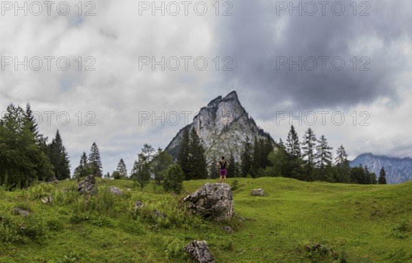 Hiker on the Schartenalm with a view of the Sparber, Osterhorn group, Salzkammergut, Salzburg province, Austria, Europe