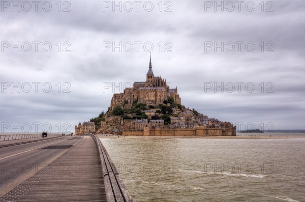 Mont Saint-Michel with access via a long bridge and surrounding water, Le Mont-Saint-Michel