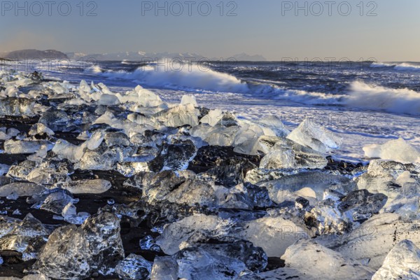 Ice floes on the beach, waves, sea, sunny, morning light, winter, Diamond Beach, Breidamerkursandur, Jökulsarlon, Iceland, Europe