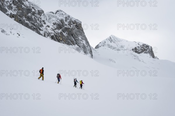 Ski tourers in a snowy mountain landscape, ascent to the Wildhorn, cloudy mood, high tour, Bernese Alps, Bernese Oberland, Switzerland, Europe