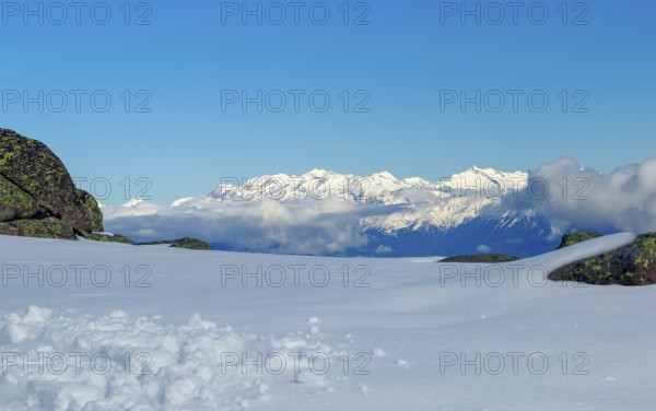Vast snowy landscape with views of white mountain peaks in South Tyrol and blue skies