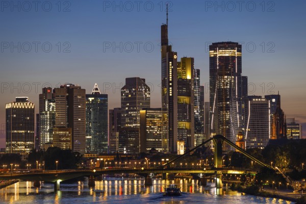 The lights of Frankfurt's banking skyline glow in the evening during the Blue Hour, Frankfurt am Main, Hesse, Germany, Europe