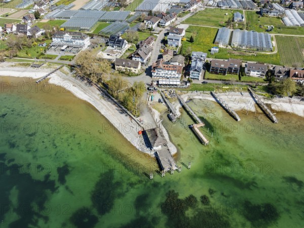 Aerial view of the southern part of the island of Reichenau at low tide and spring-like vegetation, with the landing stage and boat harbour, district of Constance, Baden-Württemberg, Germany, Europe