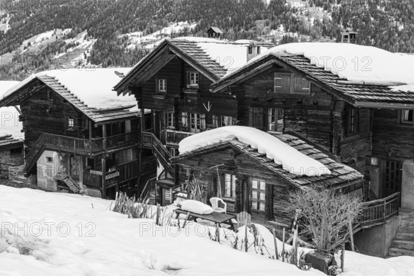 Old wooden houses with snow-covered roofs in the historic village centre, black and white photograph, Grimentz, Val d'Anniviers, Valais Alps, Canton Valais, Switzerland, Europe