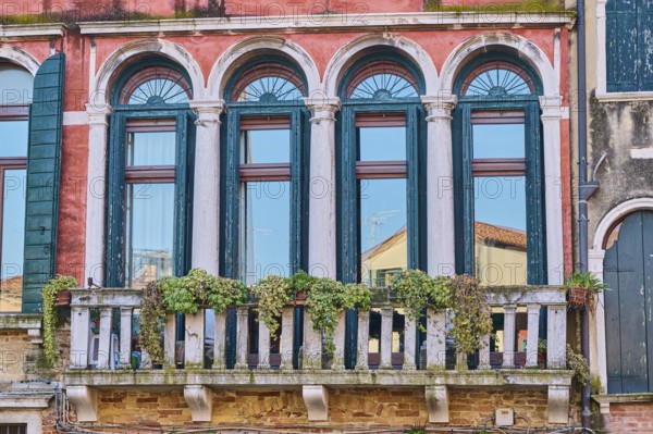 Windows of an old house on 'Campo santa margherita' town square in Venice on a sunny day in winter, Italy, Europe