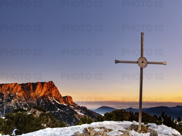 Sunrise at the summit cross of the Rauhen Kopf, behind the Untersberg, Berchtesgaden Alps, Bischofswiesen, Berchtesgadener Land, Upper Bavaria, Bavaria, Germany, Europe