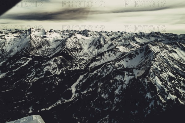 Flight over the late winter Lech Valley with a small aeroplane in Tyrol, Austria, Europe