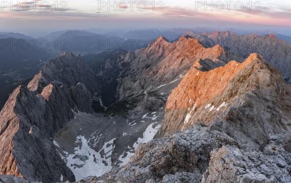Impressive rocky mountain landscape, steep mountain ridge, Jubiläumsgrat with Alpspitze, view into Höllental, mountain panorama from the summit of Zugspitze, alpenglow at sunset, Northern Limestone Alps, Wetterstein range, Bavaria, Germany, Europe