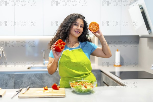Cool latin young food vlogger showing ingredients while recording a cooking tutorial at home