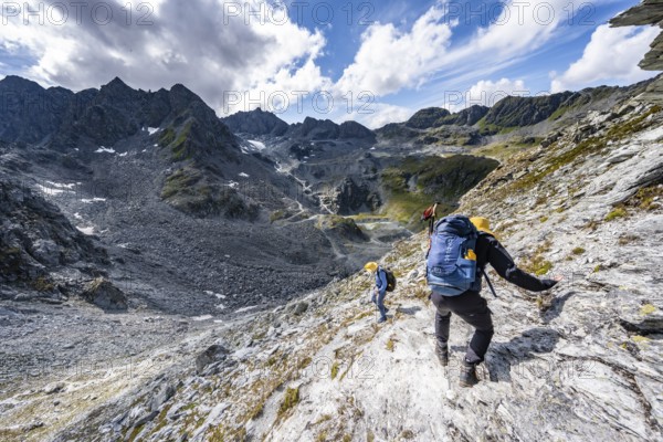 Two climbers descending a steep mountain path, ascent to the summit of Mont de la Blana, Hérménence, Valais Alps, Valais, Switzerland, Europe