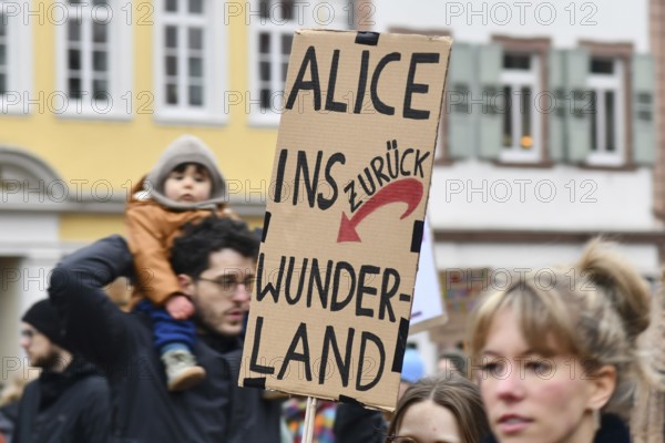 Heidelberg, Germany - February 12th 2025: Person holding up sign with text 'Fascism is not an opinion' in crowd at protest against far-right