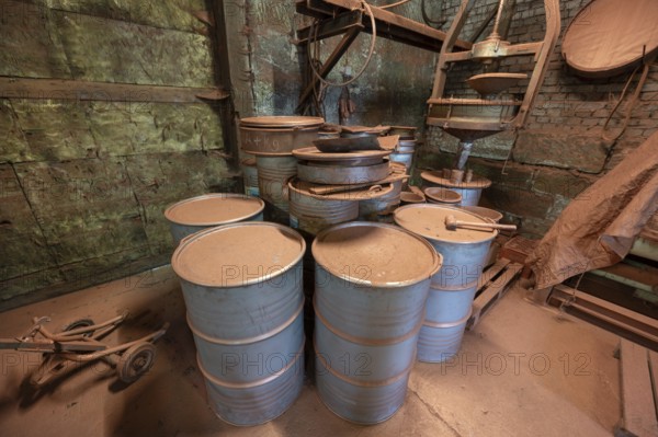 Metal barrels in the bronze powder filling room of a metal powder mill, founded in 1900, Igensdorf, Upper Franconia, Bavaria, Germany, Europe