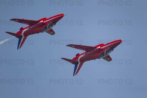 BAE Systems Hawk two aircraft of the RAF Royal air force Red Arrows display team flying, England, United Kingdom, Europe