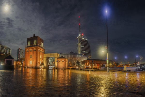 View of the old bascule bridge, the Klimahaus and a hotel in Bremerhaven at night, Bremerhaven, Bremen, Germany, Europe