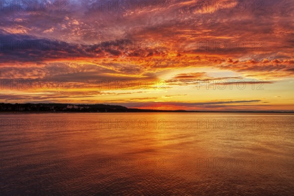 Bright orange-red sunset over the calm sea, Rügen