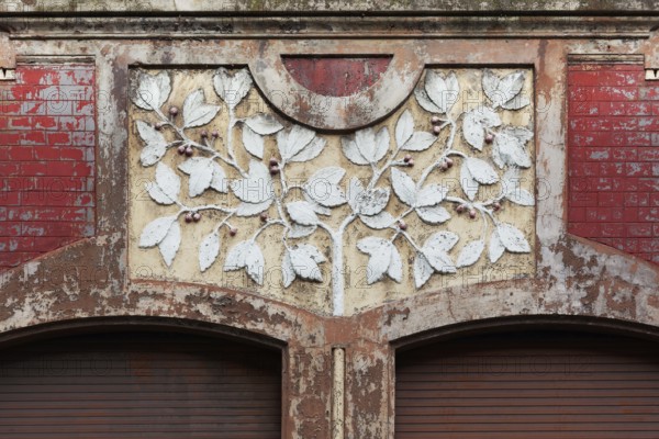 Facade decoration on a Wilhelminian style house for renovation, branches with cherries, detail, Duisburg-Neuenkamp, North Rhine-Westphalia, Germany, Europe