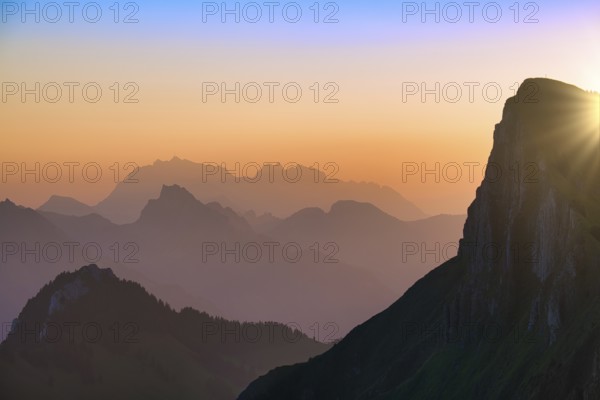 Appenzell Alps with Alpstein and Säntis at sunrise, in the foreground rock face of the Tierberg, cantons of Glarus and St. Gallen, Switzerland, Europe