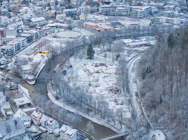 Snowy city with river, surrounded by trees and buildings, showing winter city life, Nagold, Black Forest, Germany, Europe