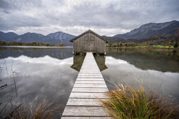 Boathouse in the lake, Lake Kochel in autumn with reflection, Upper Bavaria, Bavaria, Germany, Europe