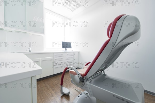 Modern, red-grey dentist's chair in a bright treatment room, Urology, Germany, Europe