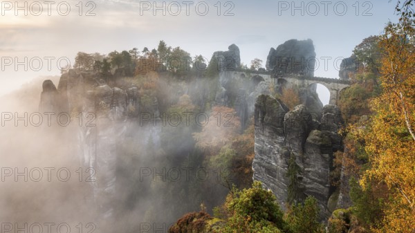 View of the Bastei Bridge with morning mist in autumn, Bastei near Rathen, Elbe Sandstone Mountains, Saxon Switzerland National Park, Saxony, Germany, Europe