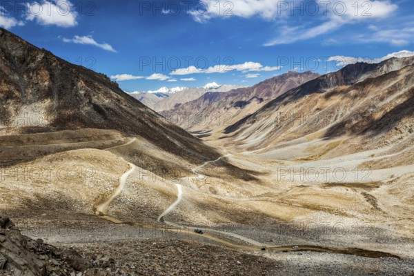 Himalayan valley landscape with road near Kunzum La pass, allegedly the highest motorable pass in the world (5602 m), Ladakh, India, Asia