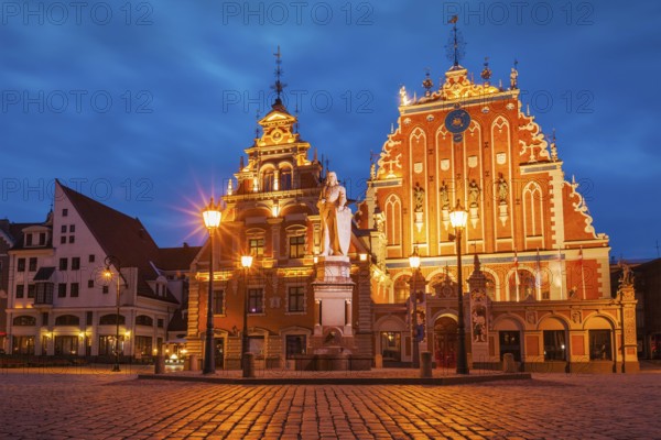 Riga Town Hall Square, House of the Blackheads and St. Roland Statue illuminated in the evening twilight, Riga, Latvia, Europe