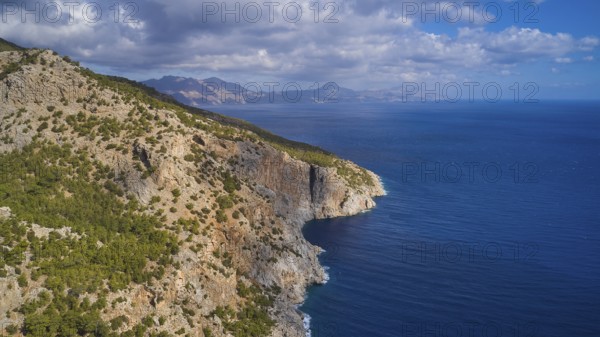 Drone shot, coastal landscape with rocky cliffs, blue sea and cloudy sky, drone shot, rocky coast, east coast, Karpathos, Dodecanese, Greek Islands, Greece, Europe