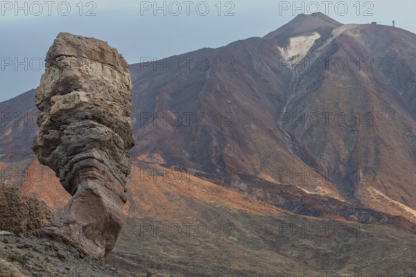 Panorama at sunrise on the Roque Chinchado, also known as the Stone Tree or Finger of God, landmark of the island, Los Roques de Garcia, behind it the Pico del Teide, 3717m, Las Cañadas, Teide National Park, Tenerife, Canary Islands, Spain, Europe