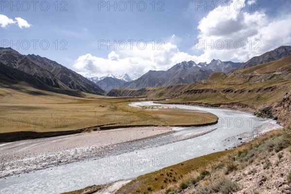 Mountain river in a valley, picturesque mountain landscape with white mountain peaks, Tian Shan Mountains, Issyk-Kul, Kyrgyzstan, Asia