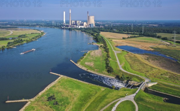 Dinslaken, North Rhine-Westphalia, Germany - Emscher estuary into the Rhine. On the right, the construction site of the new Emscher estuary in front of the decommissioned STEAG coal-fired power plant in Voerde. The mouth of the Emscher into the Rhine is being moved almost 500 metres north from Dinslaken to Voerde. Fish will then be able to swim barrier-free up the new Emscher from the Rhine through a newly created floodplain area. Following the construction of a parallel sewer, the Emscher has been completely free of sewage since January 2022. The river was previously an open, above-ground combined sewer with rainwater and wastewater