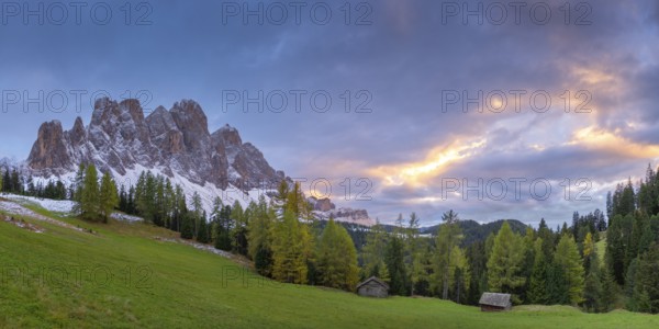 View of a part of the Geisler group in the foreground two alpine huts, sunset, Dolomites, snow, Puez-Geisler nature park Park, St. Magdalena, Funes, Villnößtal, South Tyrol, Italy, Europe