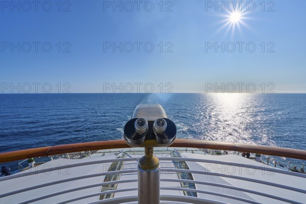 View from the ship's deck, Mein Schiff 6, under bright sunshine and blue sky, binoculars at the stern, North Sea, Norway, Europe